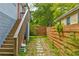 Backyard walkway between two houses leads to wooden stairs at 569 Woods Nw Dr, Atlanta, GA 30318