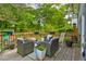 Inviting backyard deck featuring comfortable seating, potted plants, and a serene wooded backdrop at 569 Woods Nw Dr, Atlanta, GA 30318