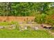 Spacious backyard with a wooded fence, various pots and decorations at 569 Woods Nw Dr, Atlanta, GA 30318