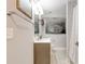 Bathroom featuring a single sink vanity, a shower with marble style walls, and a modern black and white photograph at 569 Woods Nw Dr, Atlanta, GA 30318