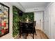 Cozy dining area with dark wood table, decorated with artificial greenery at 569 Woods Nw Dr, Atlanta, GA 30318