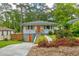 Charming bungalow with orange doors and shutters and landscaping at 569 Woods Nw Dr, Atlanta, GA 30318