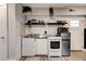 Compact kitchenette with stainless steel sink and appliances, plus modern decor at 569 Woods Nw Dr, Atlanta, GA 30318