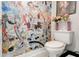 Modern powder room featuring eclectic wallpaper and a white toilet at 569 Woods Nw Dr, Atlanta, GA 30318