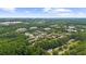 Aerial view of a neighborhood featuring mature trees and a variety of commercial and residential buildings at 615 Barrington Way, Roswell, GA 30076