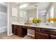 Bathroom with double sinks, wood cabinets, a large mirror, modern lighting, and a shower/tub combo at 615 Barrington Way, Roswell, GA 30076