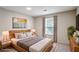 Bright bedroom featuring a comfortable queen-sized bed, stylish nightstands, and a large window at 615 Barrington Way, Roswell, GA 30076