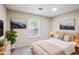 Well-lit bedroom with a comfortable bed, stylish decor, and picturesque artwork on the wall at 615 Barrington Way, Roswell, GA 30076