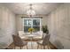 Cozy dining room featuring a chandelier, a round table with four chairs, and a large window at 615 Barrington Way, Roswell, GA 30076