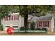 Charming two-story home featuring a well-maintained lawn, an attached two-car garage, and red shutters at 615 Barrington Way, Roswell, GA 30076