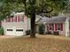 Two-story house with red shutters, a brick facade, and a two-car garage at 615 Barrington Way, Roswell, GA 30076