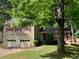 Traditional home featuring a two-car garage, complemented by mature trees and lush landscaping at 615 Barrington Way, Roswell, GA 30076