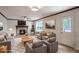 Bright living room with a stone fireplace, neutral furniture, a ceiling fan, and a large area rug at 615 Barrington Way, Roswell, GA 30076