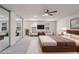 Serene main bedroom with a large bed, mirrored closet, and cozy sitting area at 615 Barrington Way, Roswell, GA 30076