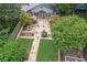 Aerial view of a landscaped backyard with a stone patio, fire pit, and manicured lawn at 101 Terrace Dr, Atlanta, GA 30305