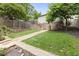 A grassy backyard is accessible via a stone pathway and includes a stone retaining wall and landscaping at 101 Terrace Dr, Atlanta, GA 30305