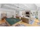Entertaining basement space featuring a pool table, stone fireplace, built-in shelving, and cozy seating at 101 Terrace Dr, Atlanta, GA 30305