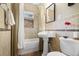Cozy bathroom with shower-tub, pedestal sink, and neutral tile at 101 Terrace Dr, Atlanta, GA 30305