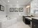 Well-lit bathroom with a soaking tub, marble finishes, and a vanity area at 101 Terrace Dr, Atlanta, GA 30305