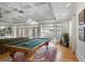 Spacious game room with a pool table and multiple French doors leading to the outdoor patio at 101 Terrace Dr, Atlanta, GA 30305