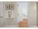 Hallway featuring hardwood floors and architectural details leading to a kitchen with white cabinets and appliances at 101 Terrace Dr, Atlanta, GA 30305