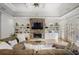 Bright living room boasts a stone fireplace, coffered ceilings, built-in shelving, and lots of natural light at 101 Terrace Dr, Atlanta, GA 30305