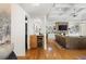 Open-concept living room features hardwood floors, a stone fireplace, built-in shelving, and a wet bar with wine fridge at 101 Terrace Dr, Atlanta, GA 30305