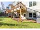 Exterior backyard view featuring a lawn, patio, and the home's architectural design with wood deck at 2270 Siskin Square Rd # 91, Duluth, GA 30096
