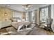 Bright bedroom features a ceiling fan, hardwood floors, and ample natural light from the windows at 2270 Siskin Square Rd # 91, Duluth, GA 30096