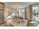 Elegant dining room featuring stylish chairs, chandelier, modern art, and a sliding glass door to outdoor living area at 2270 Siskin Square Rd # 91, Duluth, GA 30096