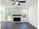 Cozy living room showcases a modern fireplace, dark hardwood floors, and windows offering a green view at 2270 Siskin Square Rd # 91, Duluth, GA 30096