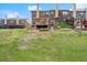 Back view of townhomes with a grassy yard and private wooden decks perfect for outdoor entertaining at 2755 Greenbridge Dr, Norcross, GA 30071