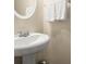 Close-up of a stylish pedestal sink with chrome fixtures and fresh white towels in a cozy bathroom at 2755 Greenbridge Dr, Norcross, GA 30071