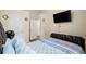 Spacious bedroom with neutral walls, modern TV, hardwood floors and large, comfy bed at 2755 Greenbridge Dr, Norcross, GA 30071