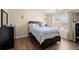 Well-lit bedroom with a queen-sized bed, dresser, and view to the yard at 2755 Greenbridge Dr, Norcross, GA 30071