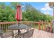 Outdoor deck with a table, chairs, and umbrella, perfect for outdoor living at 2755 Greenbridge Dr, Norcross, GA 30071