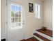 Bright entryway showcasing a white door with blinds, leading to stairs with dark wood treads at 2755 Greenbridge Dr, Norcross, GA 30071