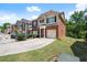Row of brick townhouses with attached garages, tidy lawns, and inviting curb appeal at 2755 Greenbridge Dr, Norcross, GA 30071