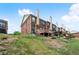 View of brick townhomes with private wooden decks and chimneys with a grassy hill in the foreground at 2755 Greenbridge Dr, Norcross, GA 30071