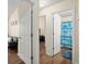 Hallway showcasing access to a living room and bathroom with coordinating hardwood floors at 2755 Greenbridge Dr, Norcross, GA 30071