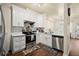 Bright kitchen features white cabinetry, stainless steel appliances, and hardwood floors at 2755 Greenbridge Dr, Norcross, GA 30071