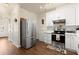 Modern kitchen features stainless steel appliances, white cabinets and subway tile backsplash at 2755 Greenbridge Dr, Norcross, GA 30071