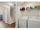 Functional laundry room with a washer, dryer, storage shelves, and easy access at 2755 Greenbridge Dr, Norcross, GA 30071
