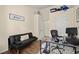 Cozy home office with dark futon couch, modern desk and chair, and hardwood style floors at 2755 Greenbridge Dr, Norcross, GA 30071