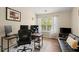 Functional office featuring two desks, a comfortable chair, and a large window at 2755 Greenbridge Dr, Norcross, GA 30071