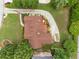 Aerial view showcasing the home's roof, landscaped yard, circular driveway, and outdoor deck with patio furniture at 5917 Southland Dr, Stone Mountain, GA 30087