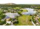 Scenic aerial view of homes bordering a lake and golf course, with mature trees and mountain views in the distance at 5917 Southland Dr, Stone Mountain, GA 30087