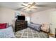 Cozy bedroom featuring two twin beds, ceiling fan, dresser, and a comfortable chair at 5917 Southland Dr, Stone Mountain, GA 30087