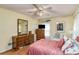 Comfortable bedroom with a double bed, ceiling fan, windows and wood flooring at 5917 Southland Dr, Stone Mountain, GA 30087