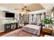 Cozy bedroom featuring a sitting area with a tv, a large rug, and bay windows at 5917 Southland Dr, Stone Mountain, GA 30087